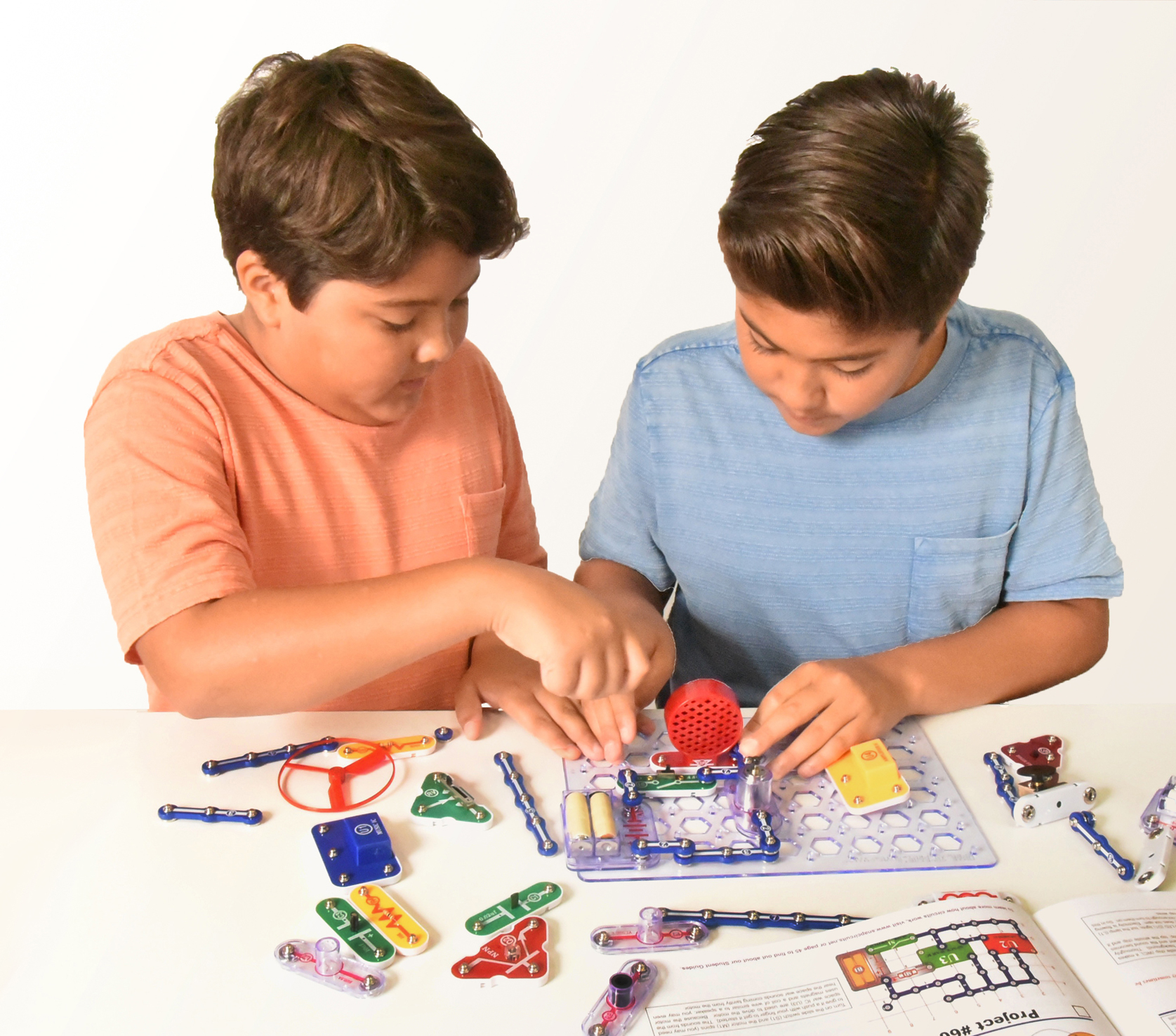 Two children building snap circuits 100